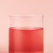 ProtoClinical k-beauty coral beauty product silhouette centered on a pale aqua background.