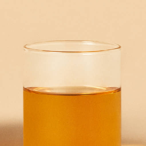 ProtoClinical k-beauty warm gold beauty product detail with a pale upper panel on a light background.