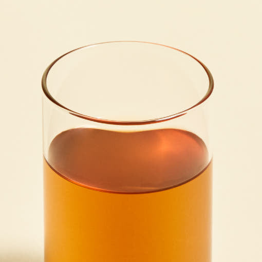 ProtoClinical k-beauty warm orange beauty product silhouette centered on a pale blue background.