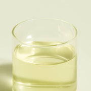 ProtoClinical k-beauty soft yellow beauty detail with muted olive vertical bands on a light background.
