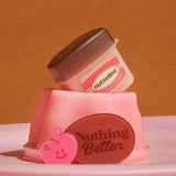 ProtoClinical k-beauty nutseline Super Nut Collagen Keyring Lip Balm 11ml single caramel-brown lip balm container with a gold keyring and matching cap standing on a warm brown background