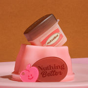 ProtoClinical k-beauty nutseline Super Nut Collagen Keyring Lip Balm 11ml single caramel-brown lip balm container with a gold keyring and matching cap standing on a warm brown background