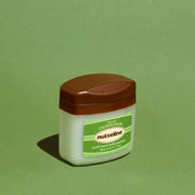 ProtoClinical k-beauty dark oval beauty compact on a soft green background.