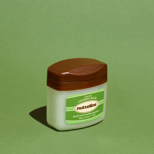ProtoClinical k-beauty dark oval beauty compact on a soft green background.