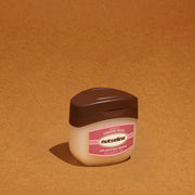 ProtoClinical k-beauty warm amber beauty graphic with a dark oval center on a tan background.