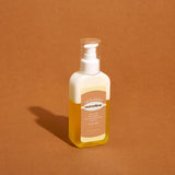 ProtoClinical k-beauty warm amber beauty product silhouette with a soft cream center on a brown background.