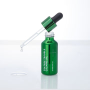 ProtoClinical k-beauty MEDIHEAL Teatree Trouble Calming Oil 10ml single upright green oil bottle centered on a pale background with soft pink side accents