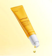 ProtoClinical k-beauty medicube Kojic Acid Turmeric Vita Eye Gel Serum 30ml yellow tube angled downward with one serum droplet falling from the white pump against a pale yellow background