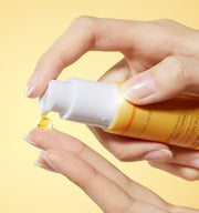 ProtoClinical k-beauty medicube Kojic Acid Turmeric Vita Eye Gel Serum 30ml close-up of a yellow tube dispensing one amber drop onto a fingertip against a soft yellow background