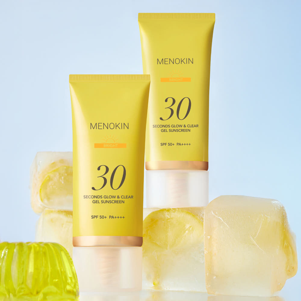 MENOKIN Glow & Clear Gel Sunscreen SPF50+ PA++++ 50ml golden sunscreen bottle on a light background