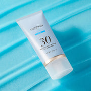 ProtoClinical k-beauty pale blue beauty bottle silhouette with a dark teal side shadow on a light aqua background.