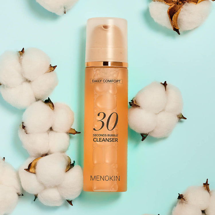 ProtoClinical k-beauty beige beauty product packaging centered on a soft aqua background.