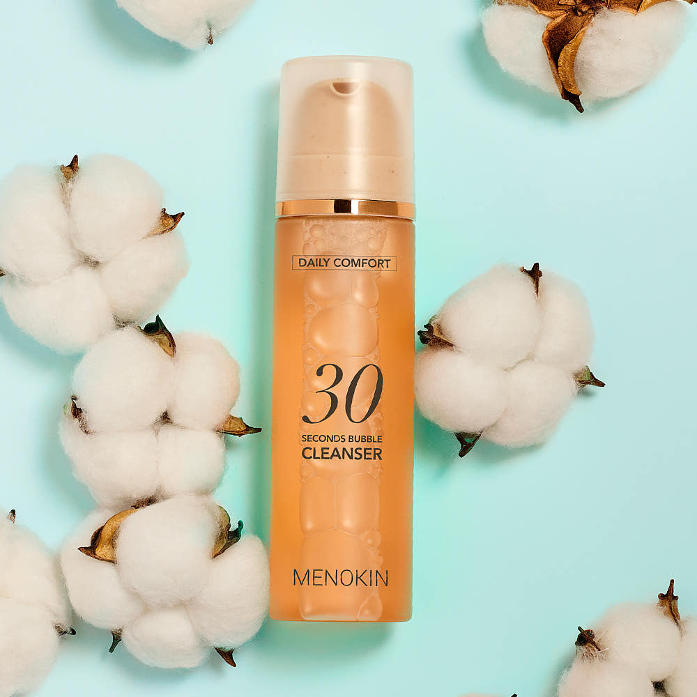 ProtoClinical k-beauty beige beauty product packaging centered on a soft aqua background.