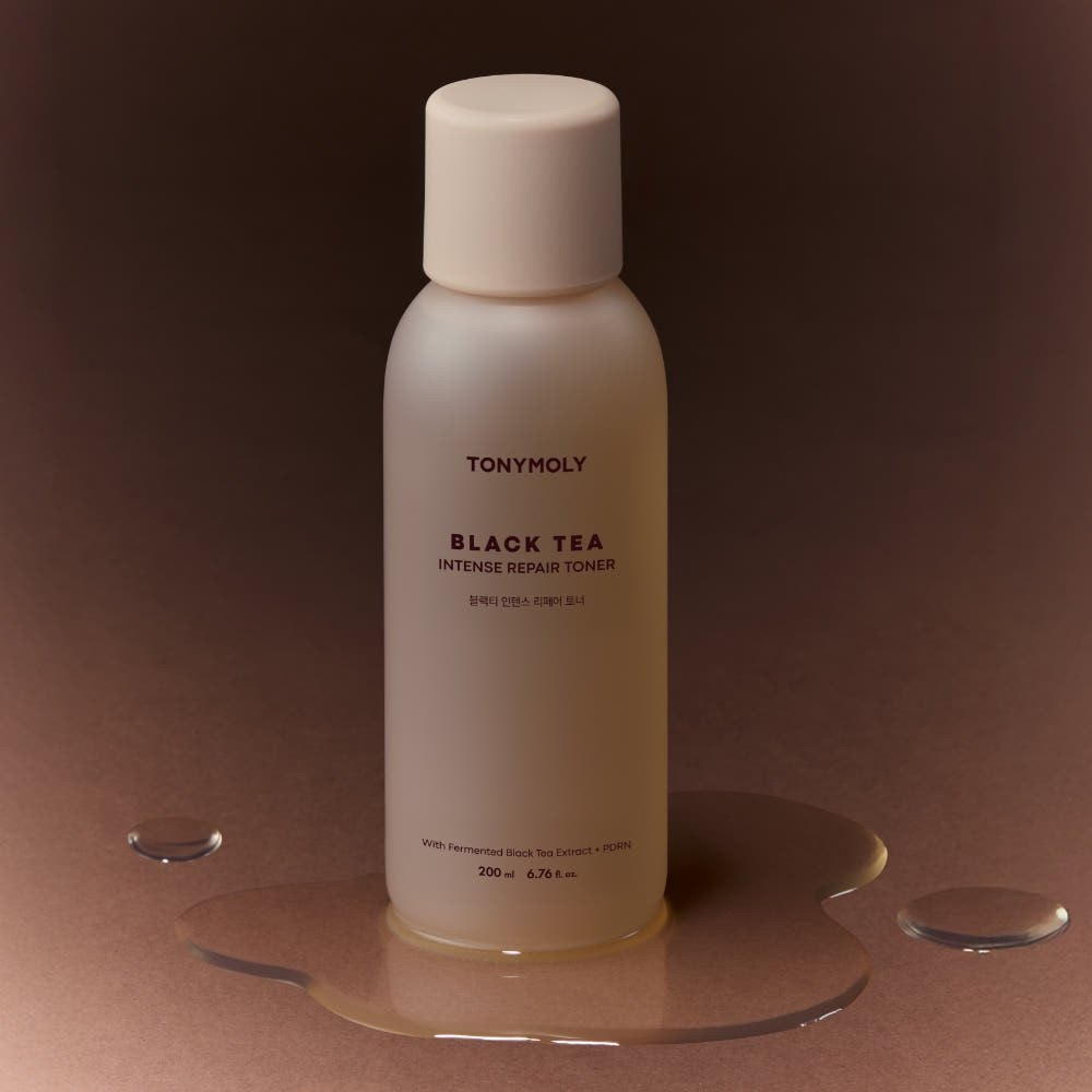 ProtoClinical k-beauty TONYMOLY Black Tea Intense Repair Toner 200ml single tall beige toner bottle centered on a dark brown background.