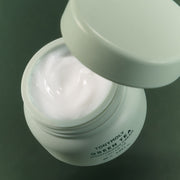 ProtoClinical k-beauty TONYMOLY Green Tea Moisturizing Cream 50ml single light green cream jar centered on a soft white and blush background.