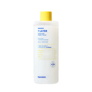 ProtoClinical k-beauty Hanskin 7 Layer Ceramide Cream Toner 500ml in a single tall pale gray toner bottle, centered upright on a white background with soft blue corner accents