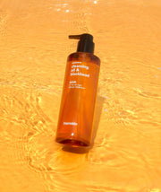 ProtoClinical k-beauty single upright orange package with a tall narrow silhouette centered on a golden yellow background.