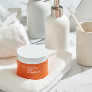 ProtoClinical k-beauty Hanskin Cleansing Balm & Blackhead 80g round brown cleansing balm jar near the lower left on a warm gray background with pale beige highlights.