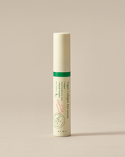ProtoClinical k-beauty AXIS-Y Vegan Collagen Eye Serum 10ml upright eye serum tube with a metal rollerball applicator beside green grape halves on a beige background