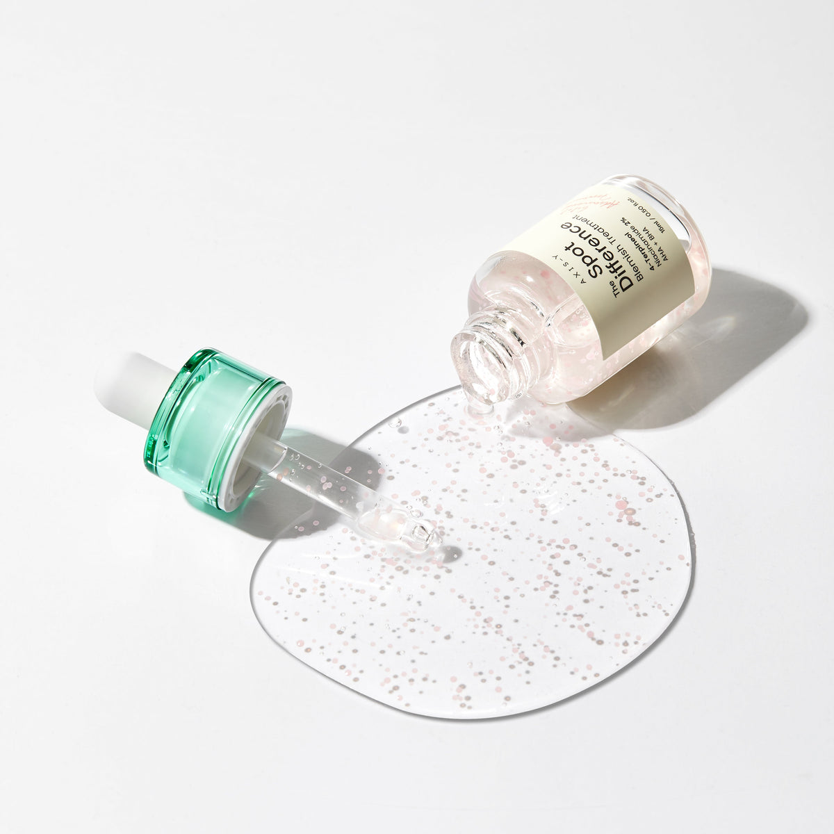 ProtoClinical k-beauty AXIS-Y Spot The Difference Blemish Treatment 15ml product infographic with key benefit text beside two pink dropper bottles on a light background