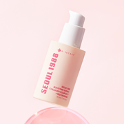 ProtoClinical k-beauty K-SECRET SEOUL 1988 BOOSTING SERUM : COLLAGEN COMPLEX 7 + RED GINSENG 30ml in a slim amber pump bottle, front-facing and centered on a soft blush background