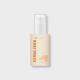 ProtoClinical k-beauty K-SECRET SEOUL 1988 GLOW SERUM : NIACINAMIDE 15% + YUJA 30ml in a single golden-yellow bottle, centered upright on a pale lavender background