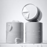ProtoClinical k-beauty two slim gray skincare bottles on a light background.
