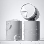 ProtoClinical k-beauty two slim gray skincare bottles on a light background.