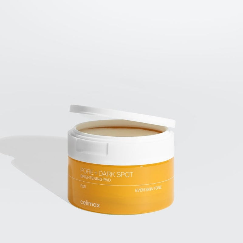 ProtoClinical k-beauty celimax Pore+ Dark Spot Brightening Pad 100ml/40ea in a yellow round jar with a white lid flipped open on a light gray background