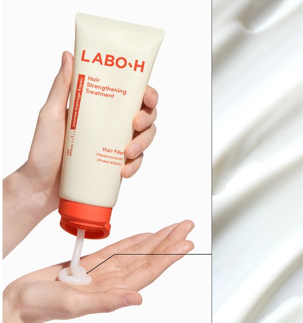 ProtoClinical k-beauty LABO-H Hair Strengthening Treatment 300ml shown as a cream treatment tube dispensing white product into an open hand on a light background