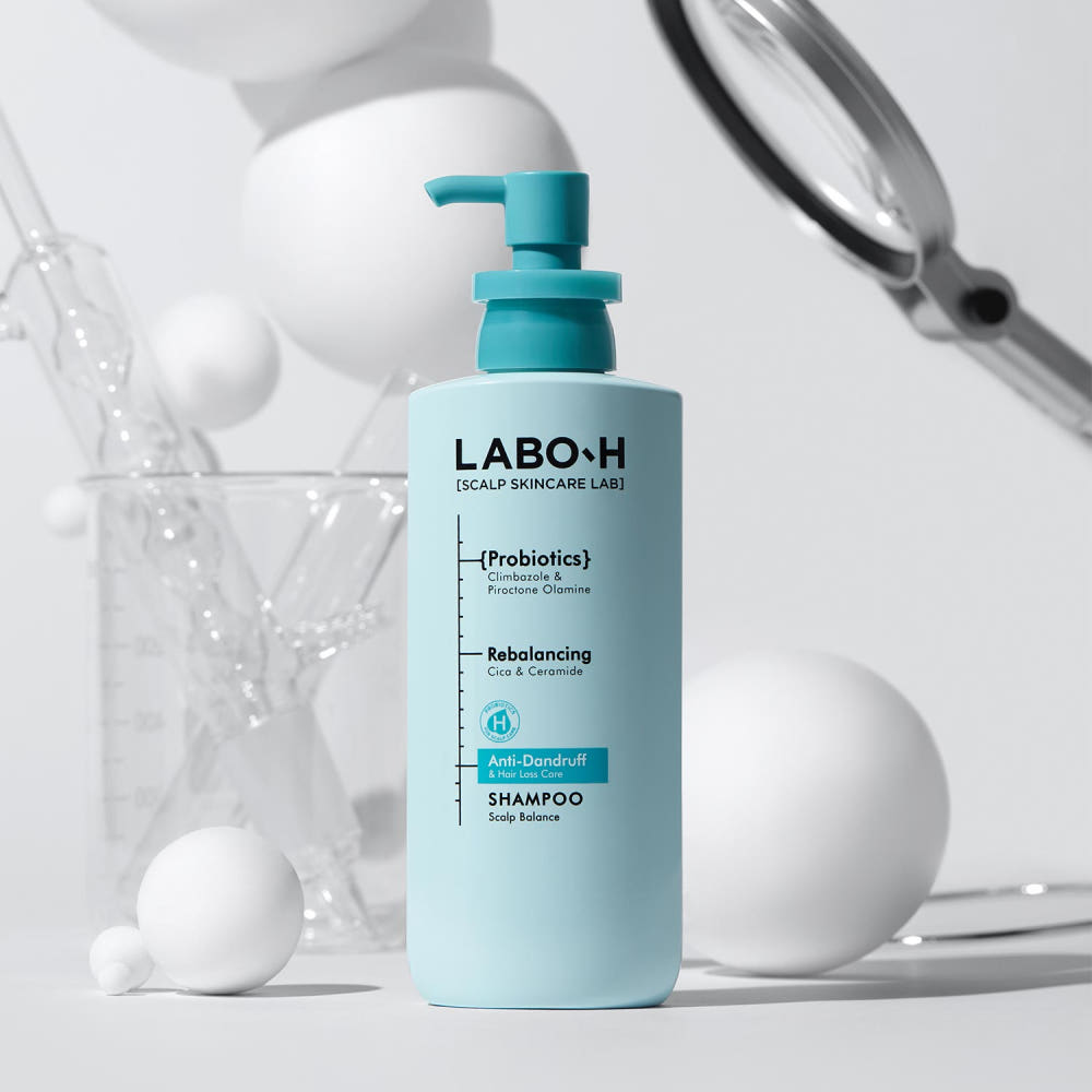 ProtoClinical k-beauty cool gray beauty product silhouette on a soft peach and pale blue background.