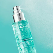 ProtoClinical k-beauty Anua PDRN Hyaluronic Acid Hydrating Capsule Mist 100ml angled clear spray bottle filled with turquoise capsules on a teal background