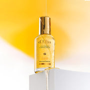 ProtoClinical k-beauty warm yellow beauty product silhouette with pale blue lower accents on a light background.