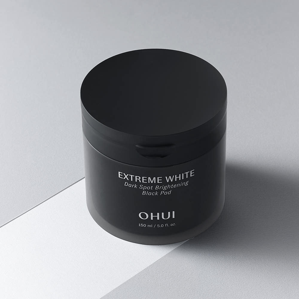 ProtoClinical k-beauty dark beauty product packaging on a light neutral background.