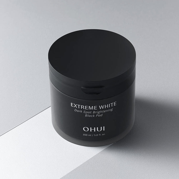 ProtoClinical k-beauty dark beauty product packaging on a light neutral background.
