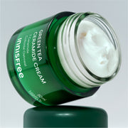 ProtoClinical k-beauty innisfree Green Tea Ceramide Cream 50ml single dark green cream jar with a matching lid centered on a light background