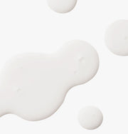 ProtoClinical k-beauty UIQ Biome Barrie Cream Mist 100ml frosted mist bottle held in one hand with the spray nozzle exposed against a beige background