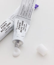 ProtoClinical k-beauty pale lavender beauty graphic with a soft diagonal form on a light background.
