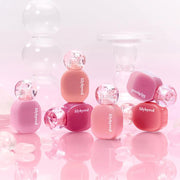 ProtoClinical k-beauty lilybyred Balming Dewy Tint 6g (6colors) rounded gradient lip tint bottle with a glossy pink cap, matching tint applicator, and a soft pink studio background