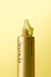 ProtoClinical k-beauty olive cosmetic product packaging on a soft yellow background.