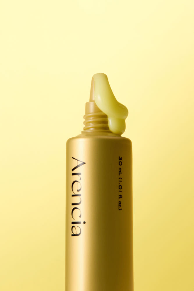 ProtoClinical k-beauty olive cosmetic product packaging on a soft yellow background.