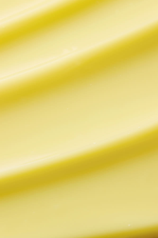 ProtoClinical k-beauty minimalist yellow beauty graphic with soft horizontal bands on a pale background.