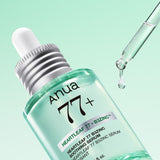 ProtoClinical k-beauty Anua Heartleaf 77 B3Zinc Soothing Serum 30ml angled mint green serum bottle with a glass dropper releasing a droplet on a pale green background