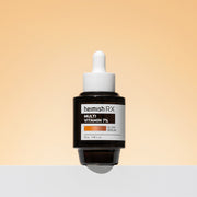 ProtoClinical k-beauty heimish RX Multi Vitamin Glow Serum 35ml single upright dark serum bottle centered on a light peach background with soft beige side shading.