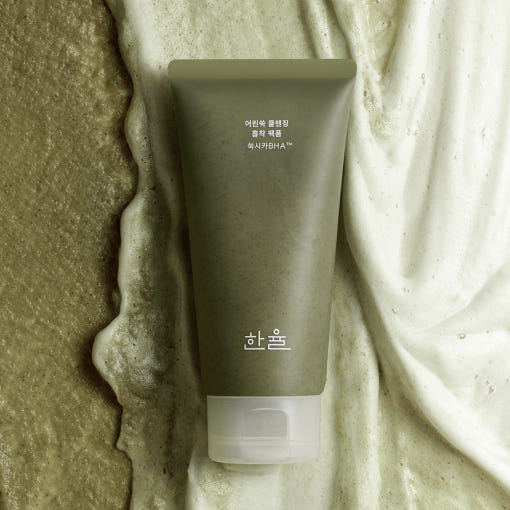ProtoClinical k-beauty beauty product packaging with a warm brown vertical center on a pale blue background.