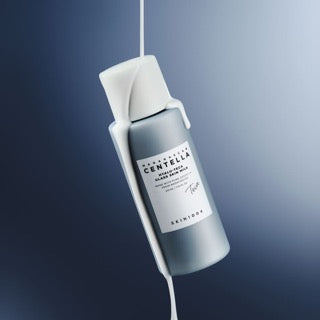 ProtoClinical k-beauty SKIN1004 Hyalu-Teca Glass Skin Milk 210ml abstract product graphic with blue-gray diagonal bands fading into a bright white gradient
