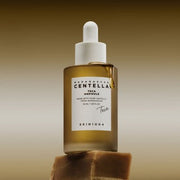 ProtoClinical k-beauty SKIN1004 Centella Teca Ampoule 50ml abstract beauty graphic with warm brown and taupe horizontal bands on a muted background.