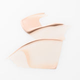 ProtoClinical k-beauty soft peach beauty graphic with pale blue side shading on a light background.
