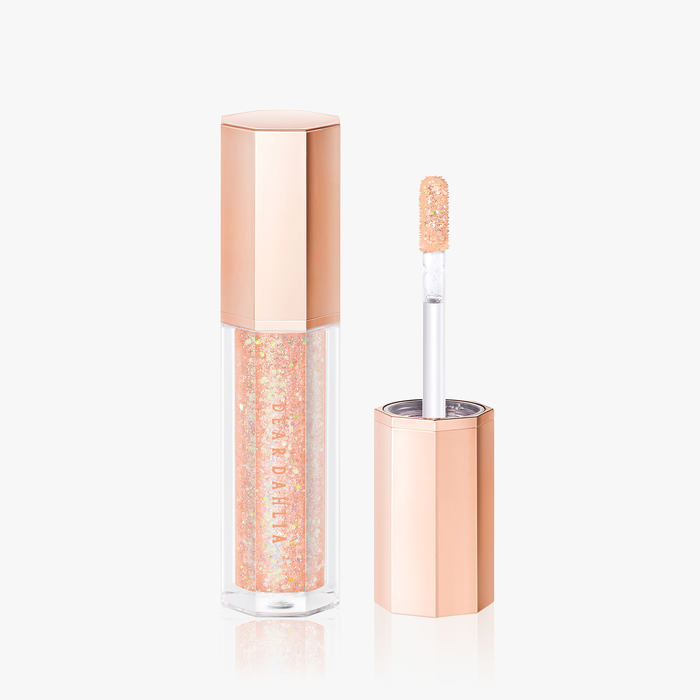 ProtoClinical k-beauty [DEAR DAHLIA] Paradise Shine Eye Sequins 4g #10 Mystic Daze beauty close-up with a centered taupe vertical form, soft peach tones, and a pale blue and white background