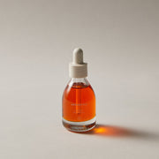 ProtoClinical k-beauty AROMATICA Organic Rosehip Oil 30ml single amber oil bottle centered on a pale pink background with green side shading